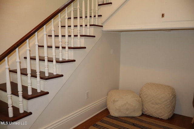 stairs with wood-type flooring