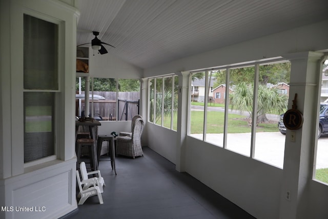 sunroom featuring lofted ceiling, plenty of natural light, and ceiling fan