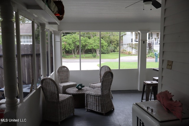 sunroom featuring decorative columns and ceiling fan