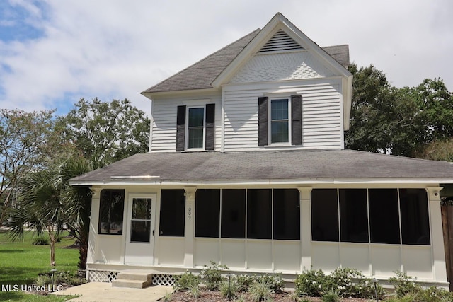 1009 Resca De La Palma St, Pascagoula, MS 39567 - rear view of house featuring a shingled roof and a sunroom
