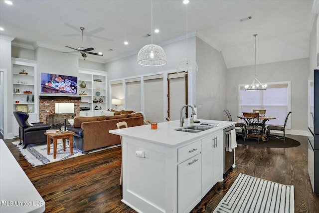 kitchen featuring dark hardwood / wood-style flooring, sink, a center island with sink, white cabinetry, and hanging light fixtures