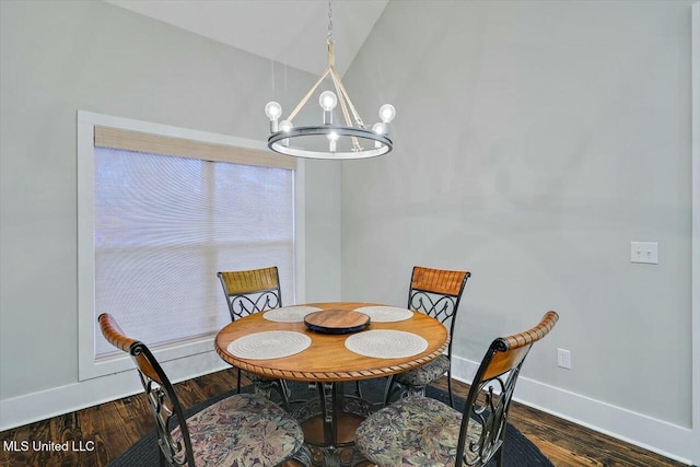 dining room featuring an inviting chandelier, dark hardwood / wood-style flooring, and vaulted ceiling