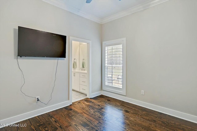 unfurnished bedroom with ceiling fan, wood-type flooring, ornamental molding, and ensuite bath