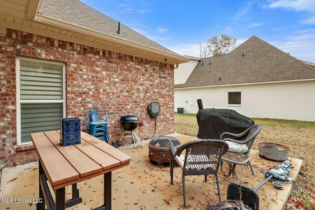 view of patio / terrace with an outdoor fire pit and grilling area