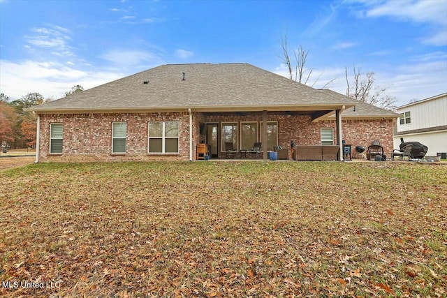 rear view of house with a lawn