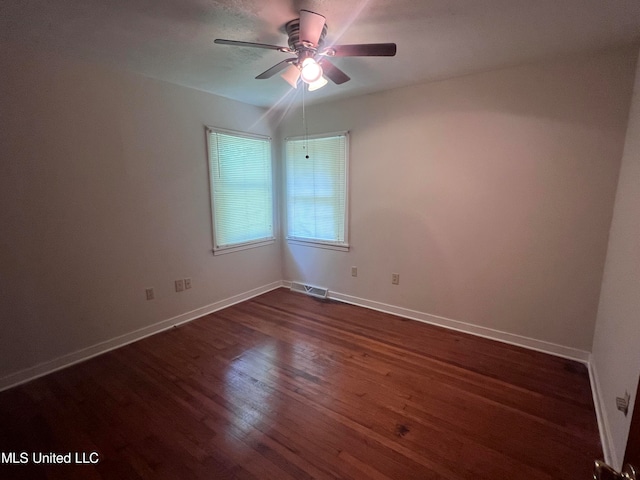 spare room featuring ceiling fan and dark hardwood / wood-style flooring