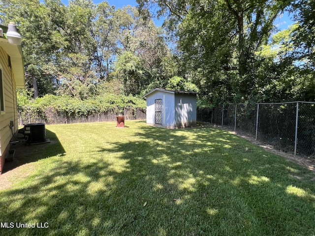 view of yard with central AC and a storage shed