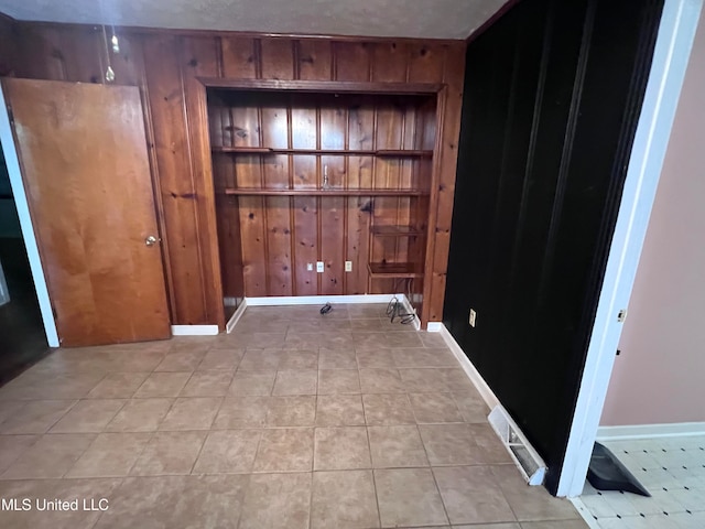 spare room featuring wooden walls