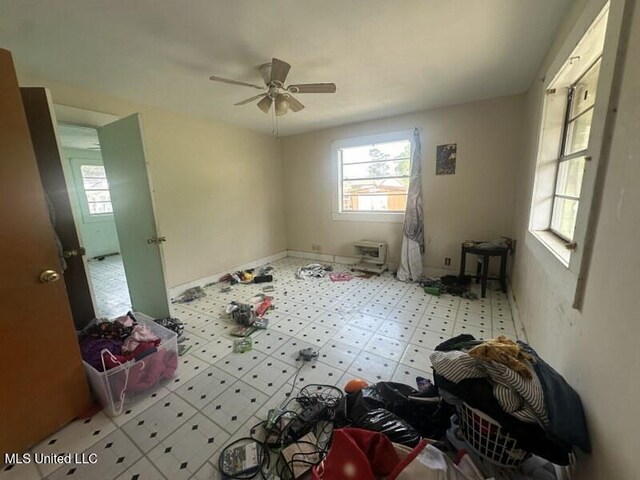 221 N W St, Mendenhall, MS 39114 - empty room featuring healthy amount of natural light, tile patterned floors, a ceiling fan, and baseboards