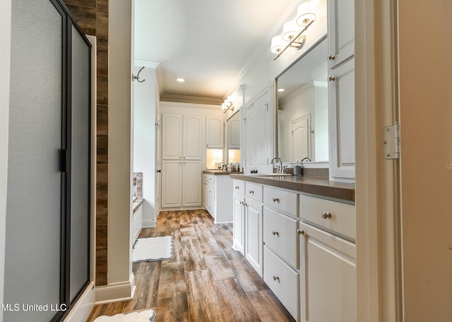 124 Westerly Pl, Madison, MS 39110 - full bath with crown molding, wood finished floors, an enclosed shower, vanity, and recessed lighting