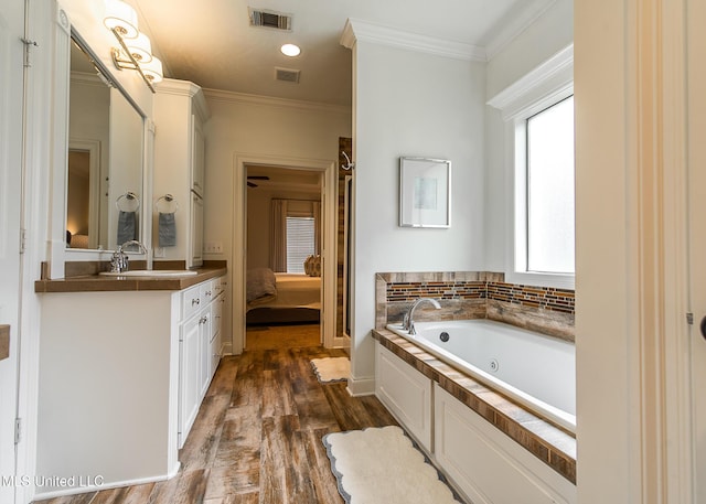 124 Westerly Pl, Madison, MS 39110 - bathroom featuring ensuite bathroom, wood finished floors, a jetted tub, ornamental molding, and vanity