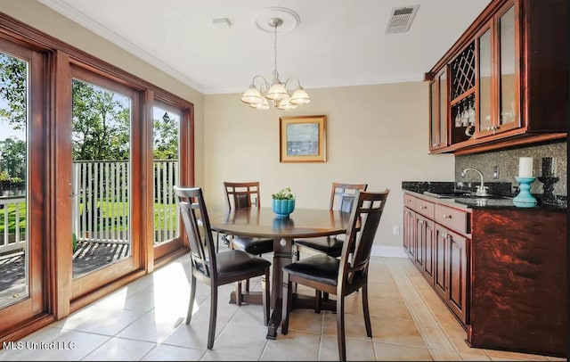 dining room with light tile patterned floors, a notable chandelier, visible vents, baseboards, and ornamental molding