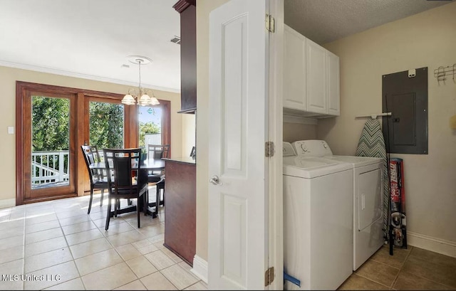 washroom featuring light tile patterned floors, separate washer and dryer, baseboards, cabinet space, and electric panel