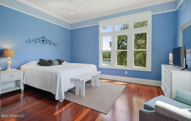 bedroom featuring ornamental molding, baseboards, and wood finished floors