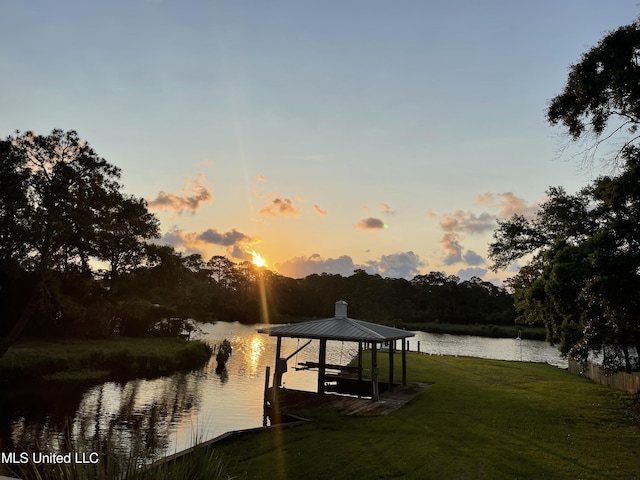 dock area featuring a water view and a lawn