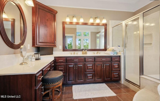 bathroom with a stall shower, tile patterned flooring, crown molding, and vanity