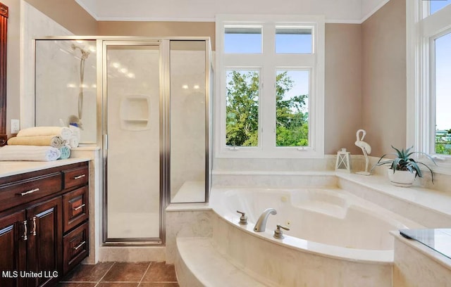 bathroom featuring tile patterned flooring, a garden tub, a shower stall, and vanity