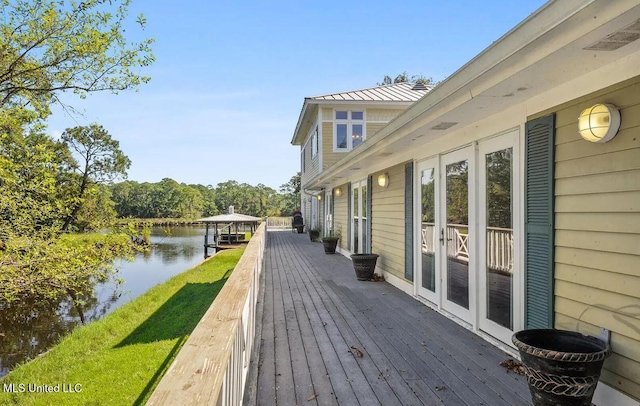 deck featuring french doors and a water view