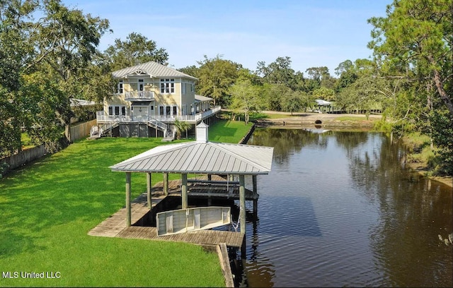 view of dock with a water view, a yard, stairway, and fence