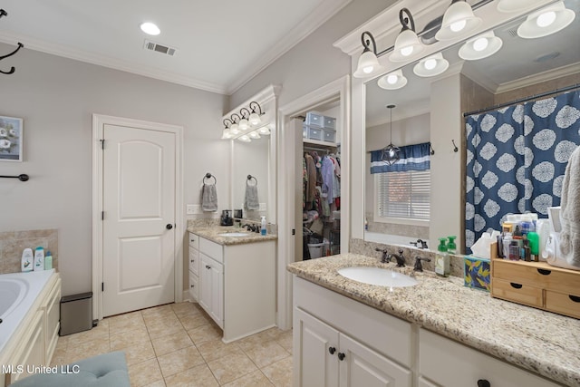 bathroom featuring tile patterned flooring, vanity, crown molding, and walk in shower