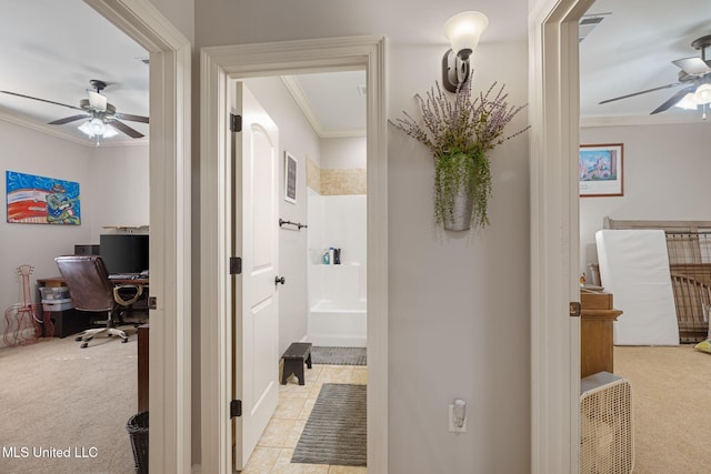 hall with light colored carpet and ornamental molding