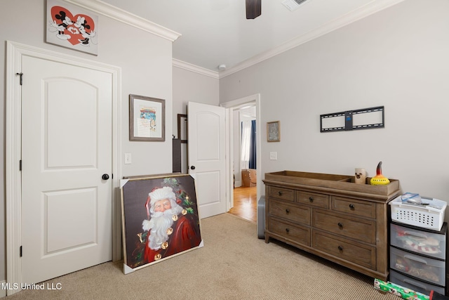 bedroom with light carpet, ceiling fan, and ornamental molding