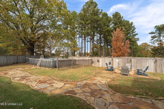 view of yard with a fenced in pool