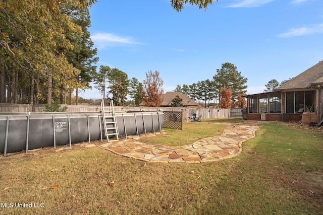 view of yard featuring a fenced in pool and a sunroom