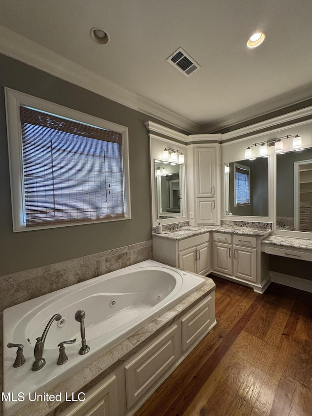 402 Ironwood Pl, Madison, MS 39110 - bathroom with wood finished floors, vanity, ornamental molding, visible vents, and a whirlpool tub