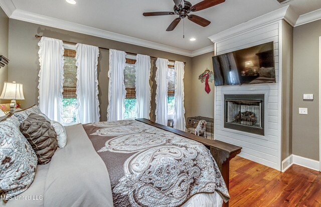 402 Ironwood Pl, Madison, MS 39110 - bedroom with multiple windows, crown molding, a large fireplace, and wood finished floors