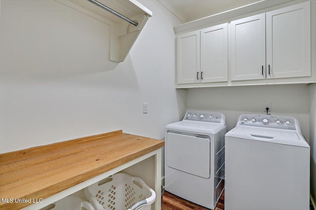 laundry area featuring ornamental molding, cabinets, and independent washer and dryer