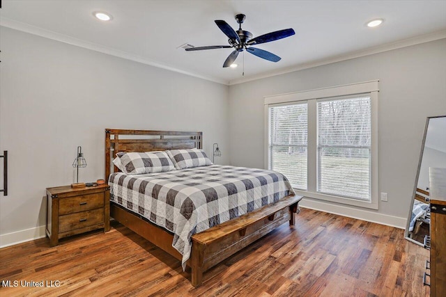 bedroom featuring ceiling fan, hardwood / wood-style flooring, and ornamental molding