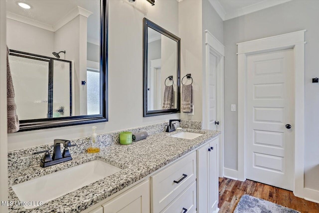 bathroom with hardwood / wood-style floors, an enclosed shower, vanity, and ornamental molding