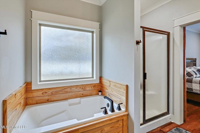 bathroom featuring independent shower and bath