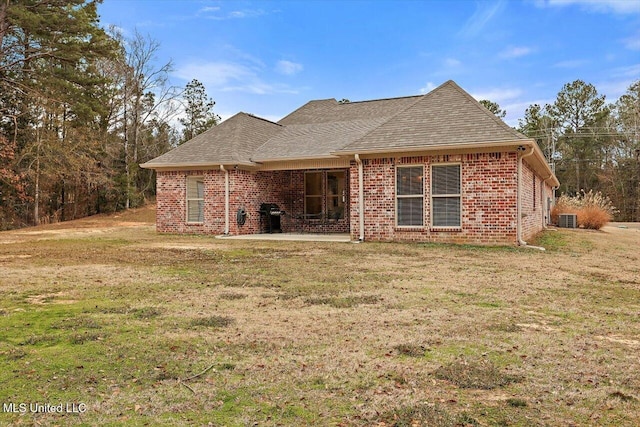 back of property featuring a patio area, a lawn, and central air condition unit