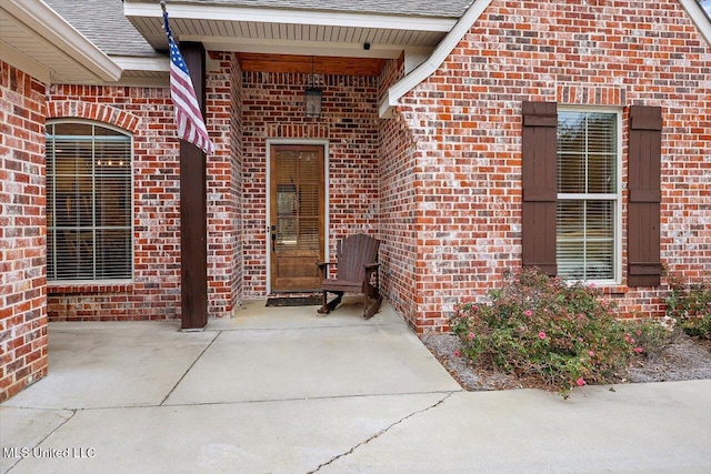 view of exterior entry featuring a patio