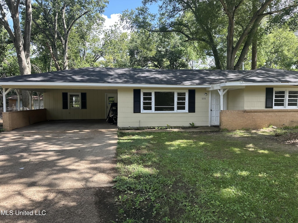1038 Brookley St, Jackson, MS 39212 - ranch-style home with a carport, concrete driveway, a front yard, and brick siding