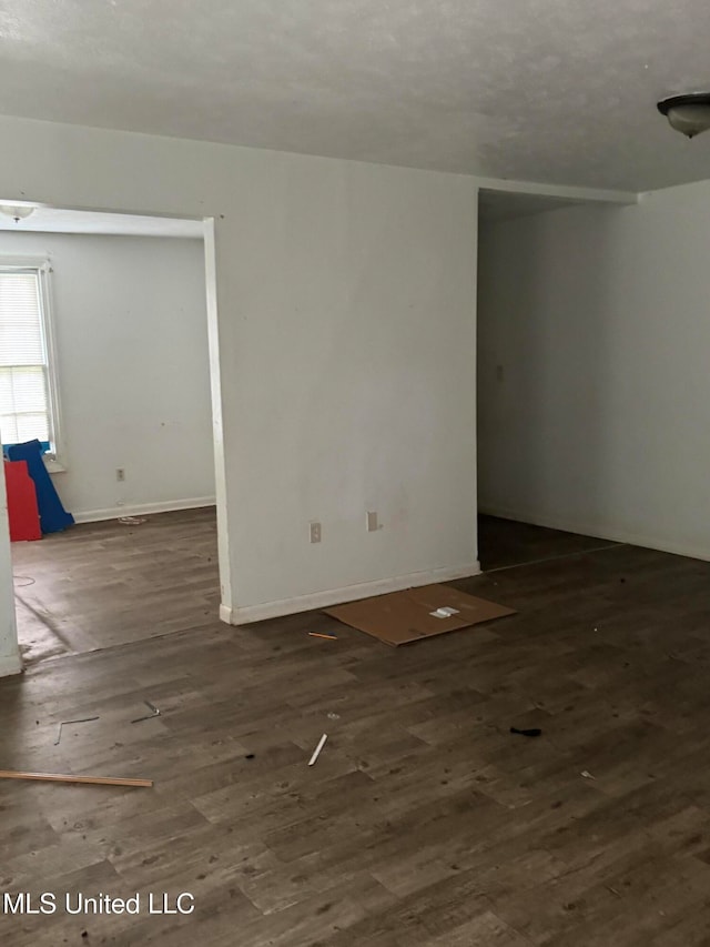 spare room with dark hardwood / wood-style flooring