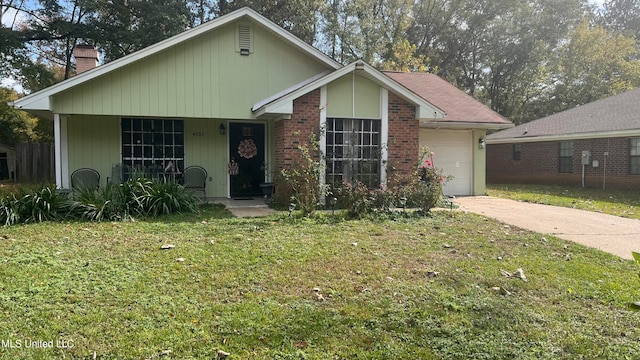 view of front facade with covered porch, a garage, and a front yard