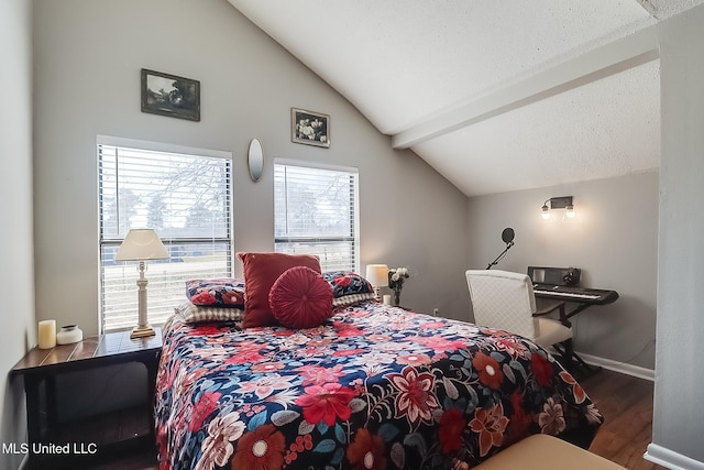 bedroom with lofted ceiling with beams, a textured ceiling, baseboards, and wood finished floors