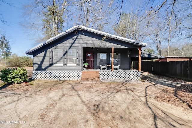 bungalow with a porch and fence