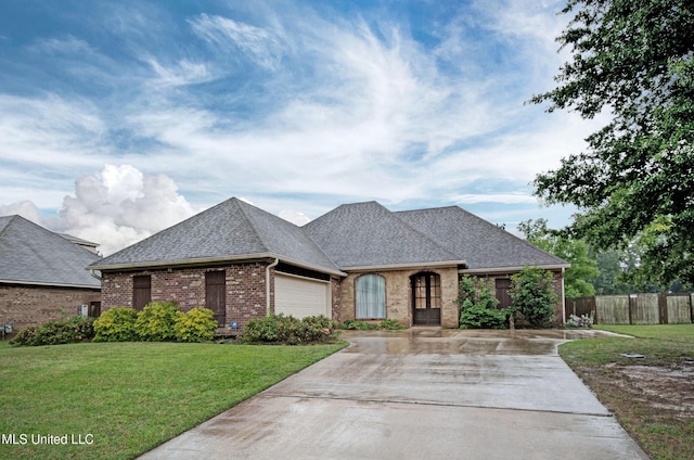 135 Mason Way, Madison, MS 39110 - french country home with concrete driveway, brick siding, an attached garage, and a shingled roof