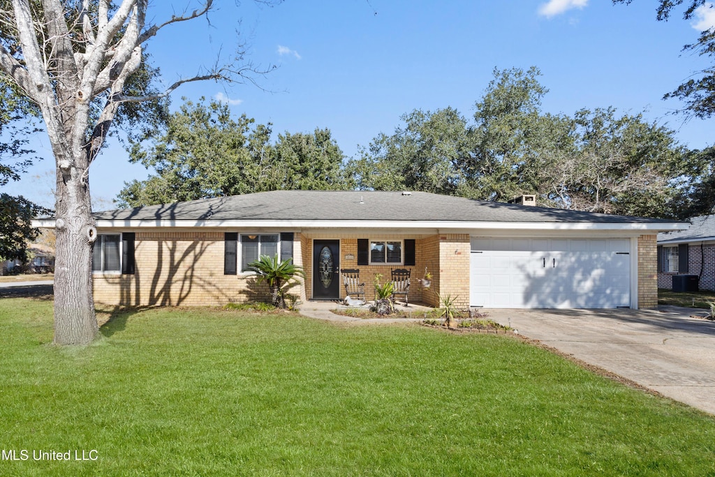 single story home featuring central AC unit, a porch, a garage, and a front yard