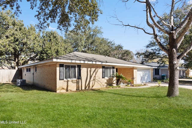 view of front of property featuring central AC unit, a front yard, and a garage