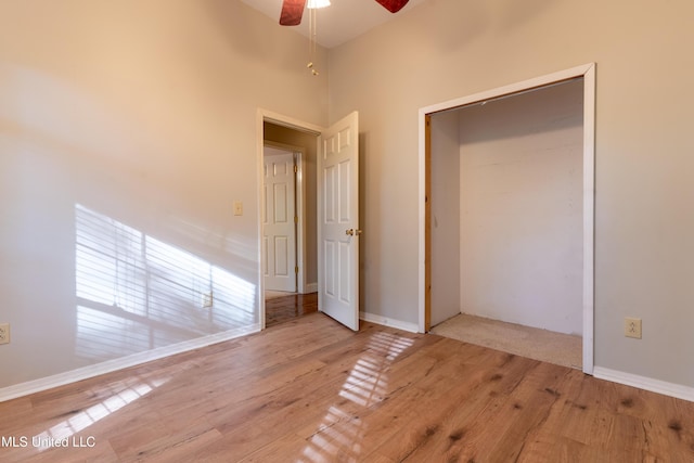 unfurnished bedroom featuring wood finished floors, a ceiling fan, and baseboards