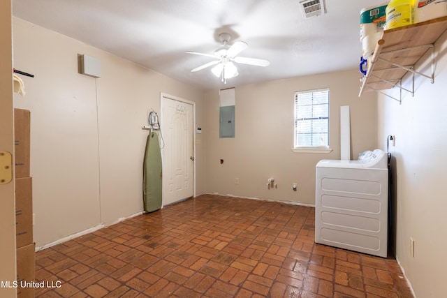 spare room with electric panel, a ceiling fan, washer / dryer, brick patterned flooring, and baseboards