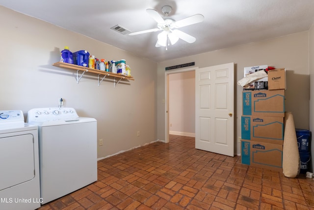 laundry area featuring washing machine and clothes dryer, ceiling fan, brick flooring, and baseboards