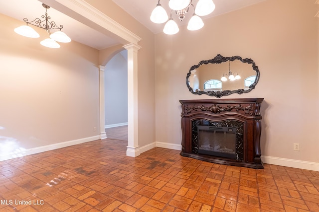 hall with a chandelier, brick floors, arched walkways, and baseboards
