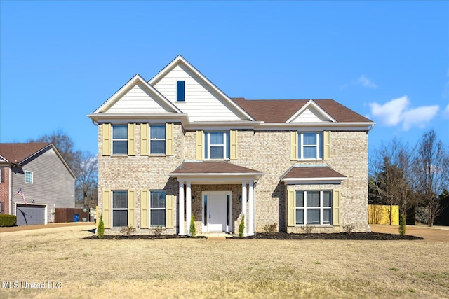 view of front facade featuring a front lawn and brick siding