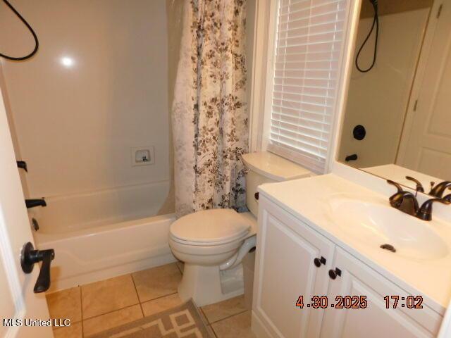 5881 Morganton Dr, Olive Branch, MS 38654 - bathroom with vanity, shower / bathtub combination with curtain, tile patterned floors, and toilet